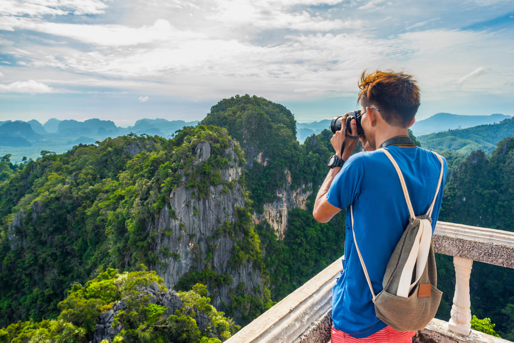 A Tourist is Taking Photo of Mountains