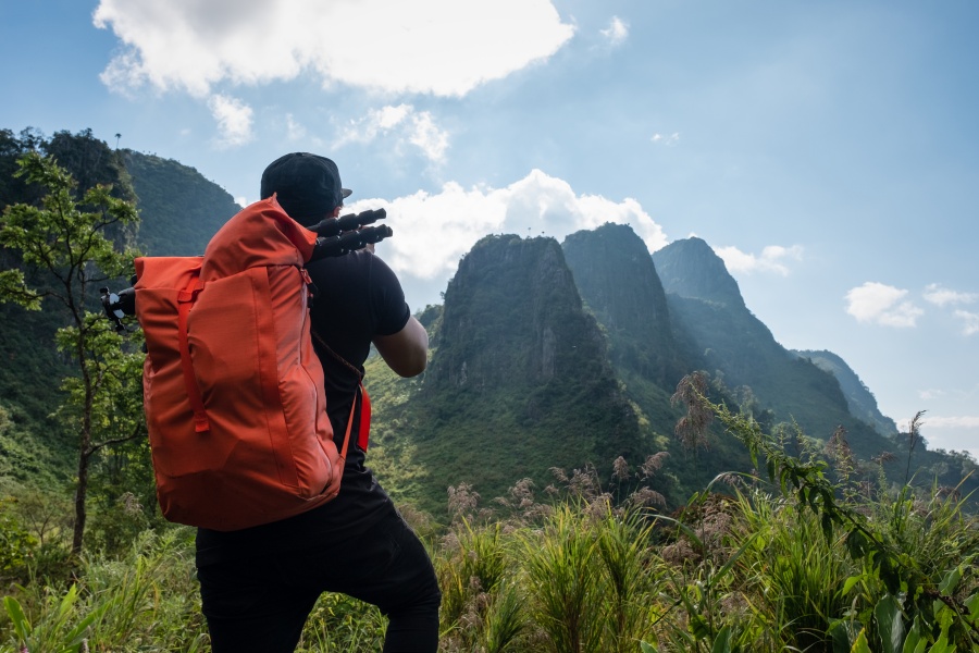 Man,Backpacker,Standing,Take,A,Photo,With,Tropical,Mountain,On