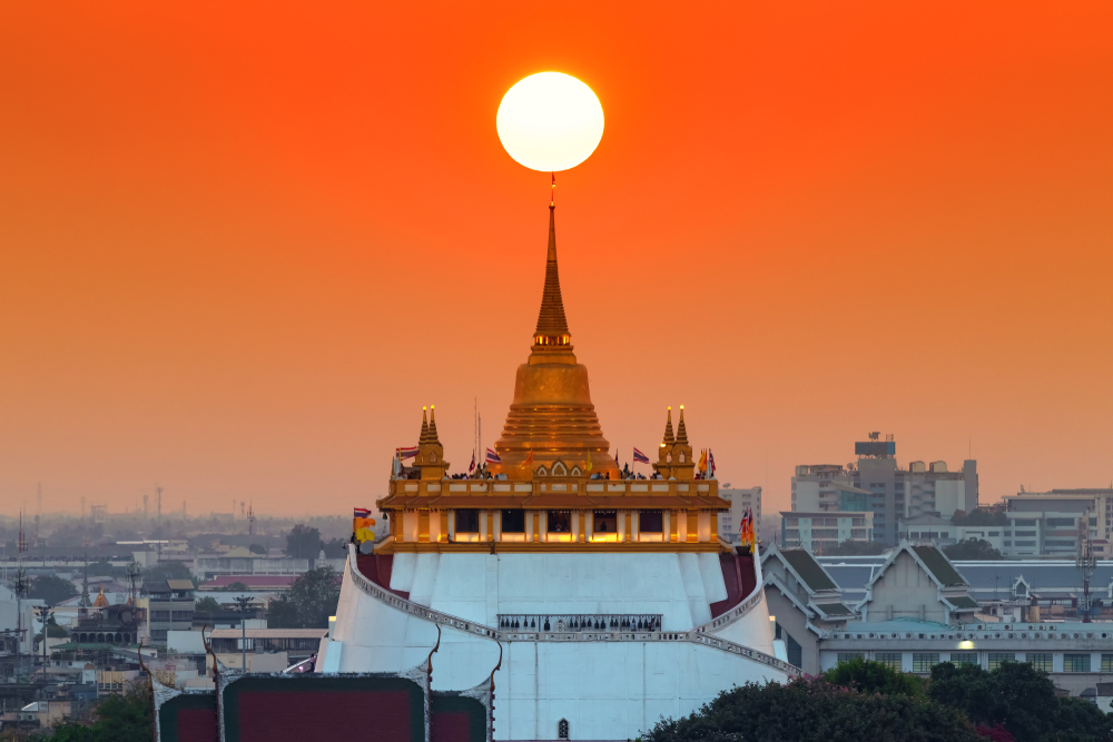 Sunset over Wat Saket with the sun in the middle