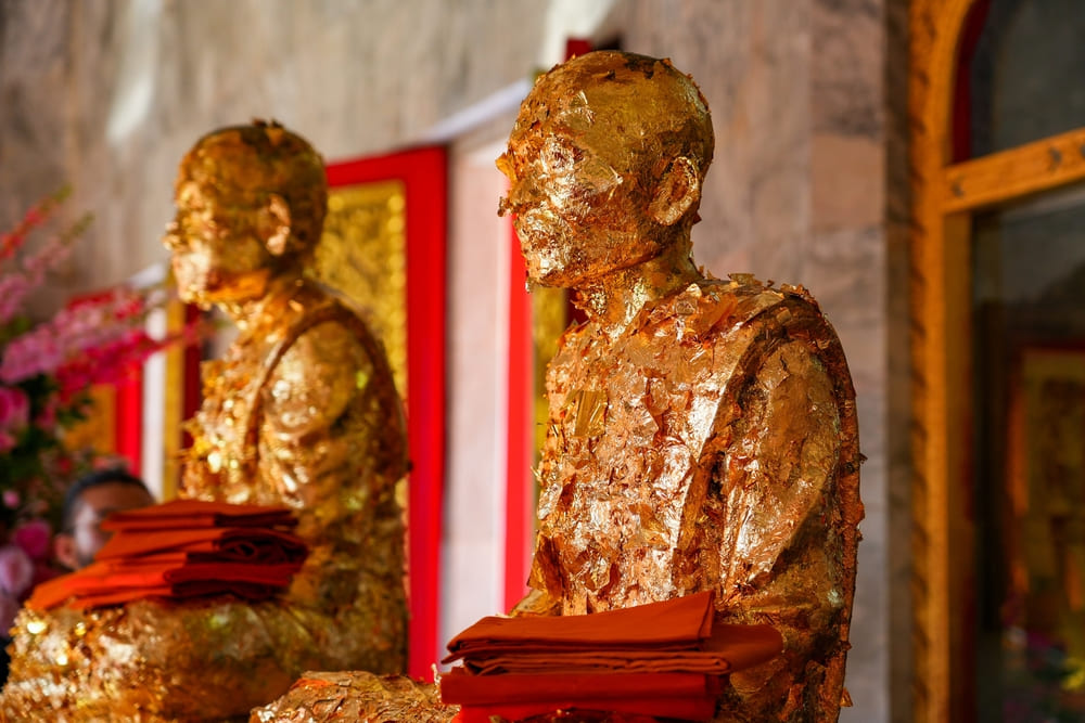 Gold-leaf covered statues of Luang Pho Chaem and Luang Pho Chuang