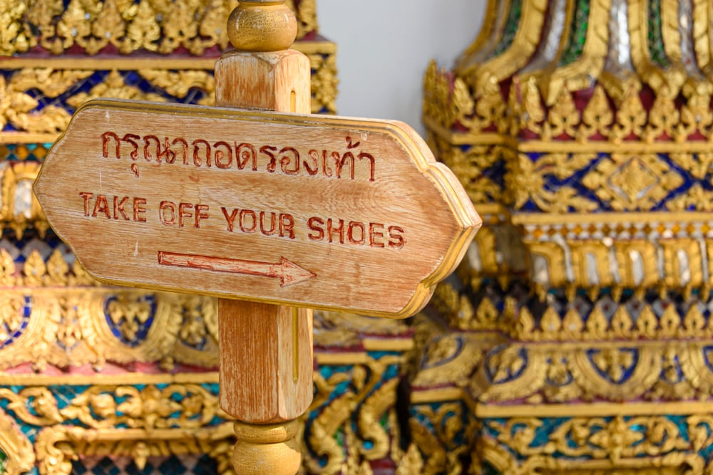 Sign of taking off shoes at a temple in Thailand