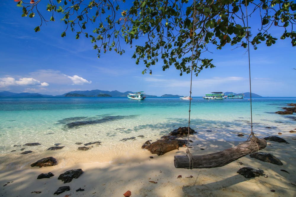Wooden swing on the beach and clear sea water at Koh Wai, Trat