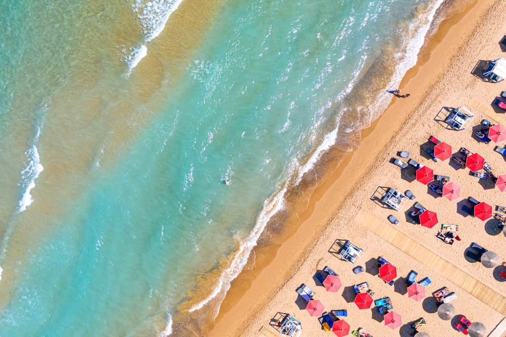 Loungers and umbrellas on Banana Beach with turquoise sea water