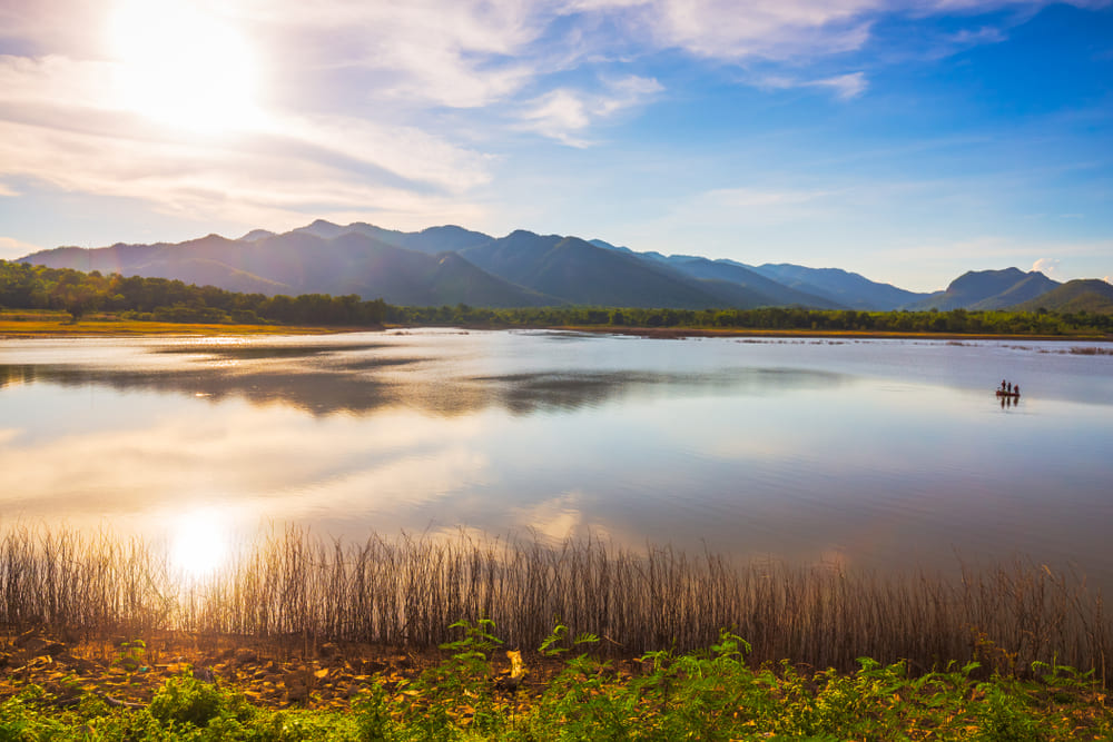 Sunset view with mountain range and water at Chao Ram Reservoir, Sukhothai