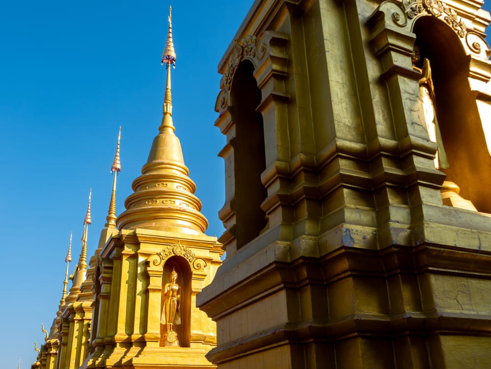 Row of golden Chedis at Wat Phiphat Mongkon
