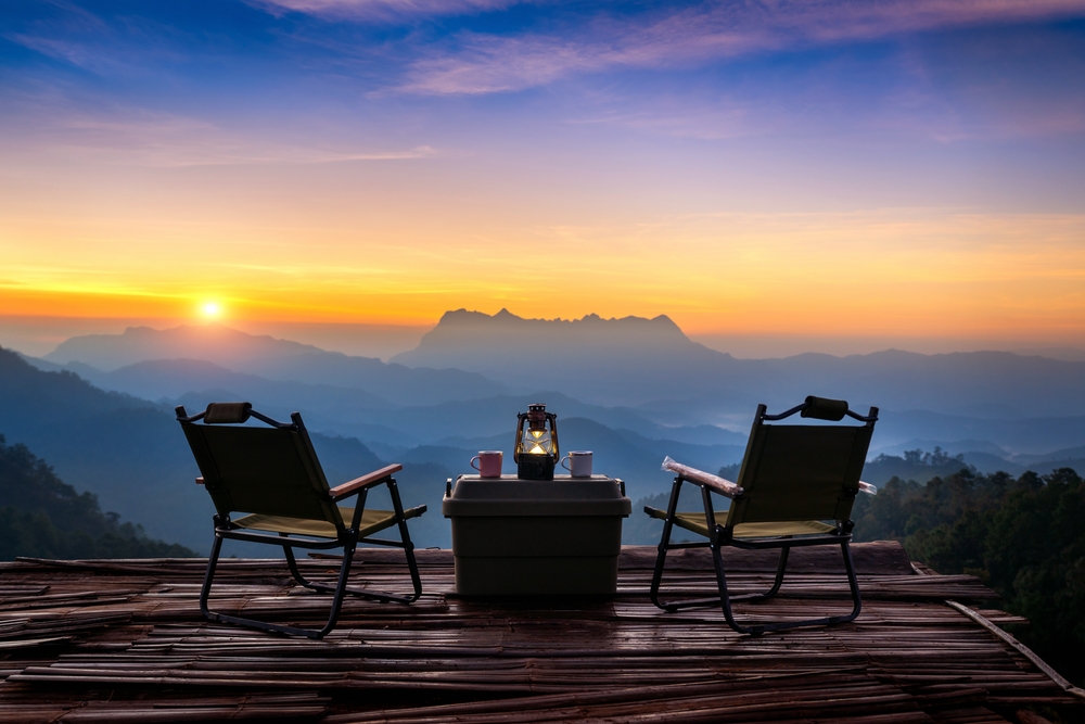 Two camping chairs overlooking mountain range in Chiang Mai