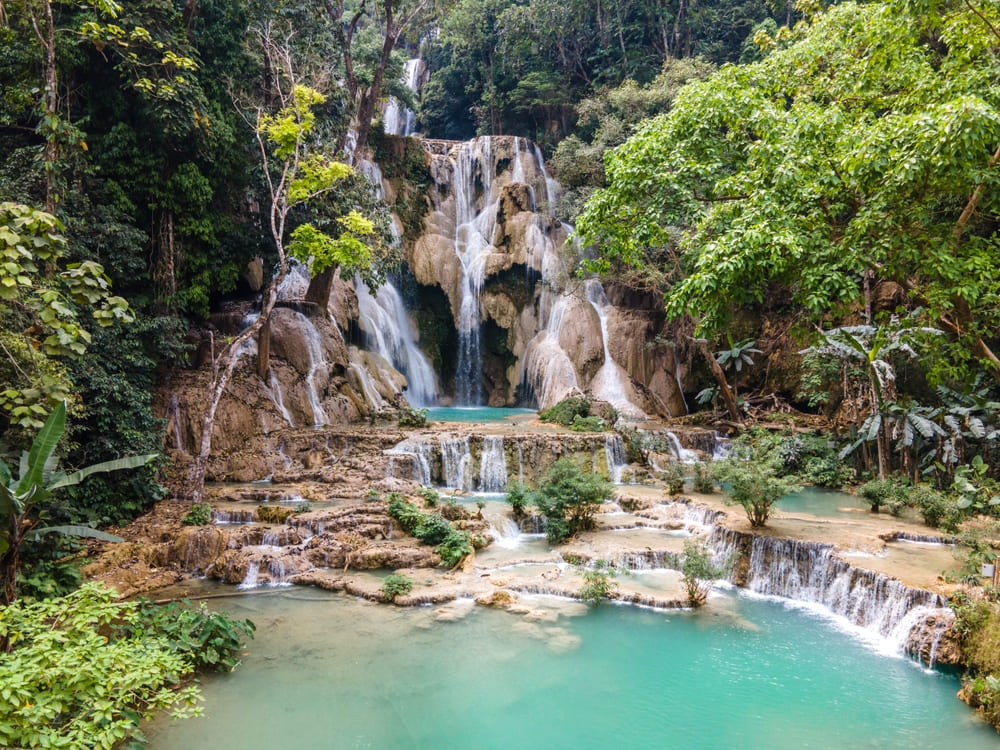 Turquoise water flowing at Kuang Si Waterfall