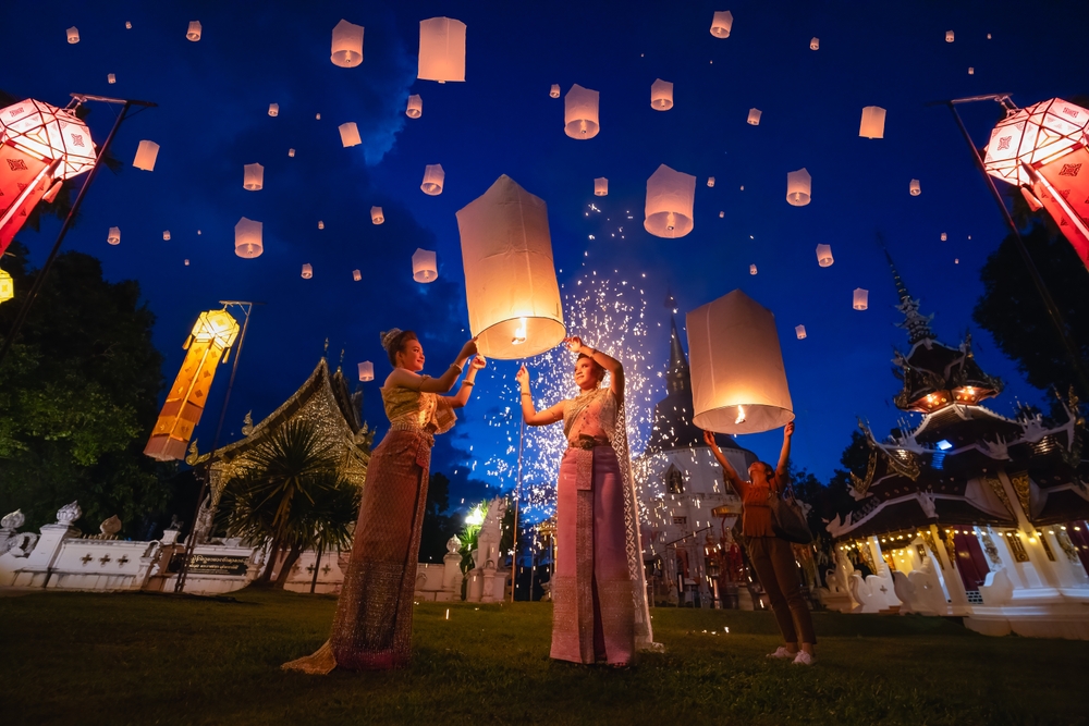 Two women releasing sky lanterns in Yee Peng Festival