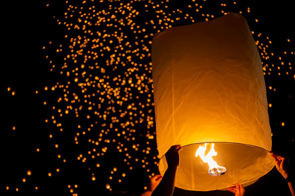 Big glowing sky lantern being released into the sky in Yee Peng Festival