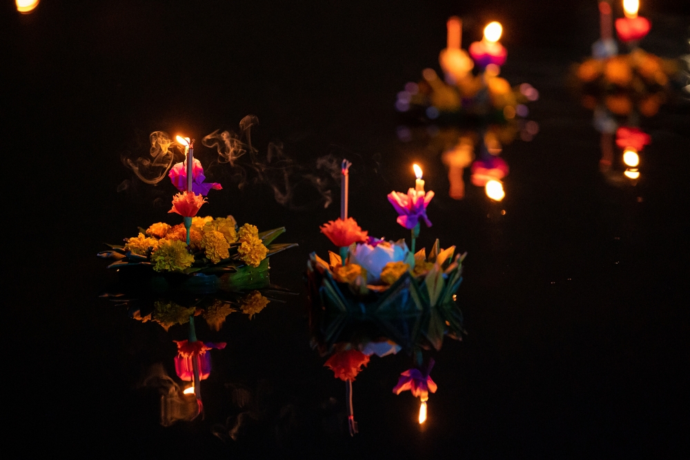 Floating krathong with candles lit