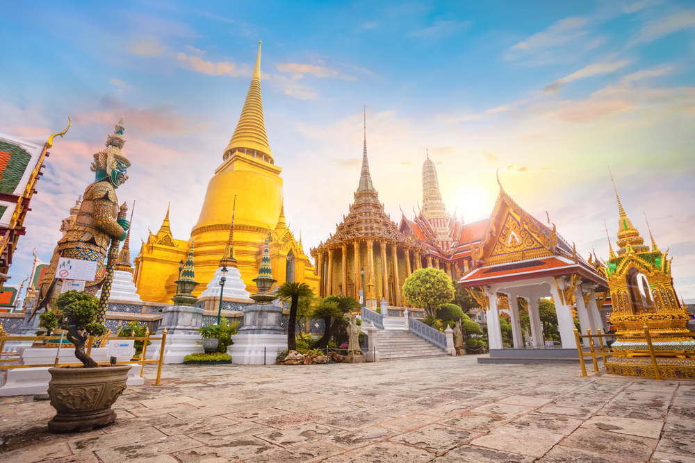 Temple grounds of Wat Phra Kaew in Bangkok, with golden pagoda and temple structures