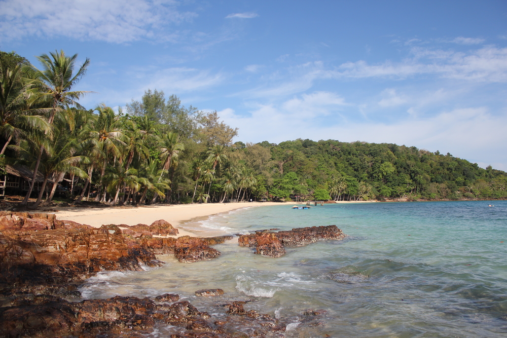 White sandy beach with rocky shoreline and clear sea at Koh Wai, Trat, Thailand