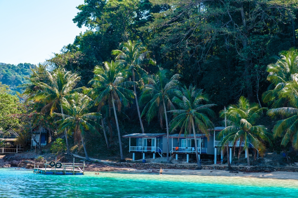 Beachfront bungalows under palm trees at Koh Wai island, Trat, Thailand