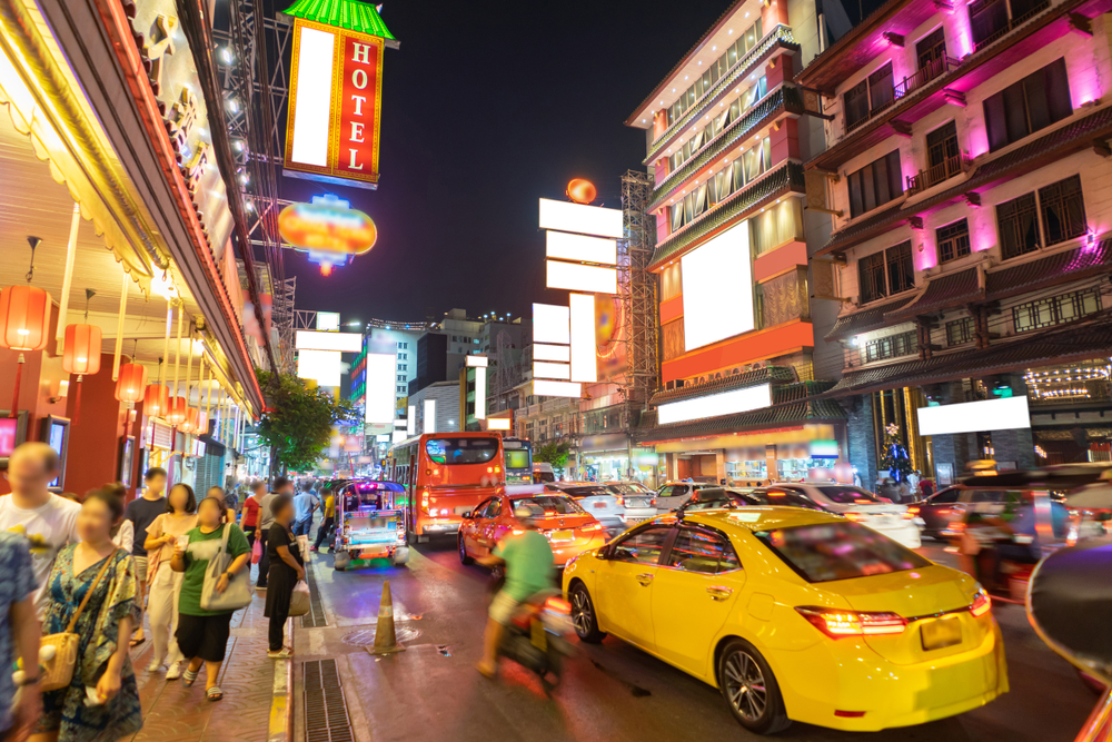 Busy road with neon signs in Bangkok’s Chinatown, Yaowarat Road