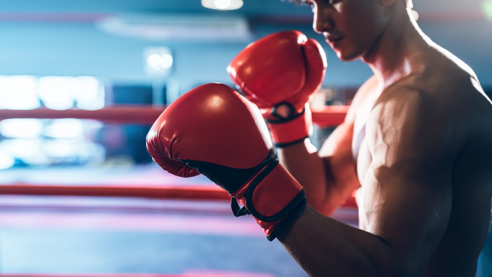 Man with boxing gloves in boxing ring