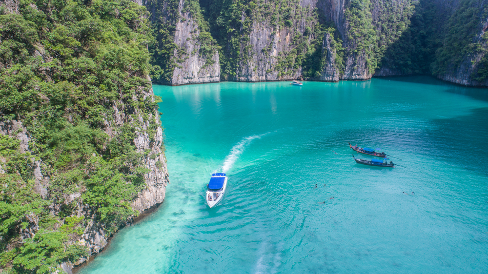 Boats on the clear blue waters at Pileh Lagoon in Krabi, Thailand