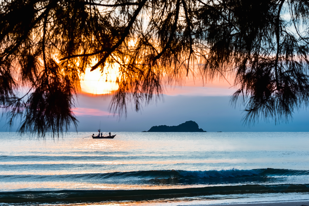 Small fishing boat in the sea during the sunset in Hua Hin, Thailand