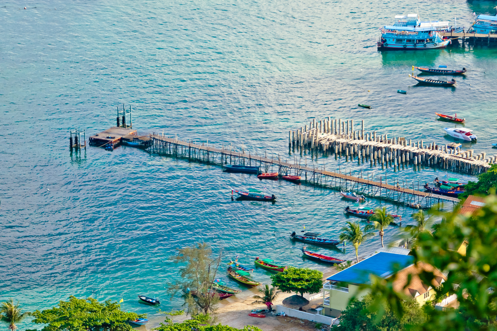 Top view of Koh Tao bay pier with longtail boats and ferries around