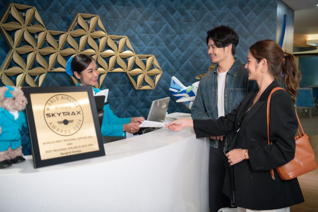 A business class traveler flying with Bangkok Airways, preparing to access the Blue Ribbon Club Lounge.