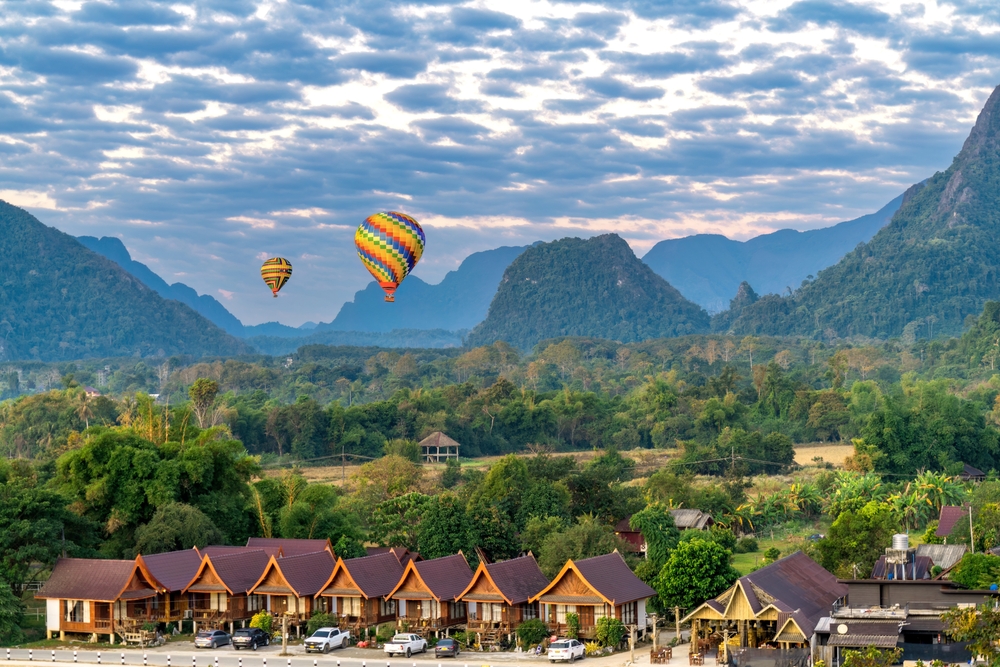 Top view of Vangvieng with hot air balloons and mountain range in the back