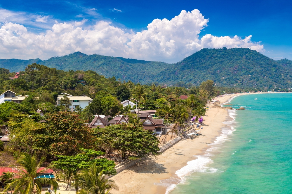Top view of Lamai beach in Koh Samui, Thailand with mountains and lush jungles, and turquoise sea