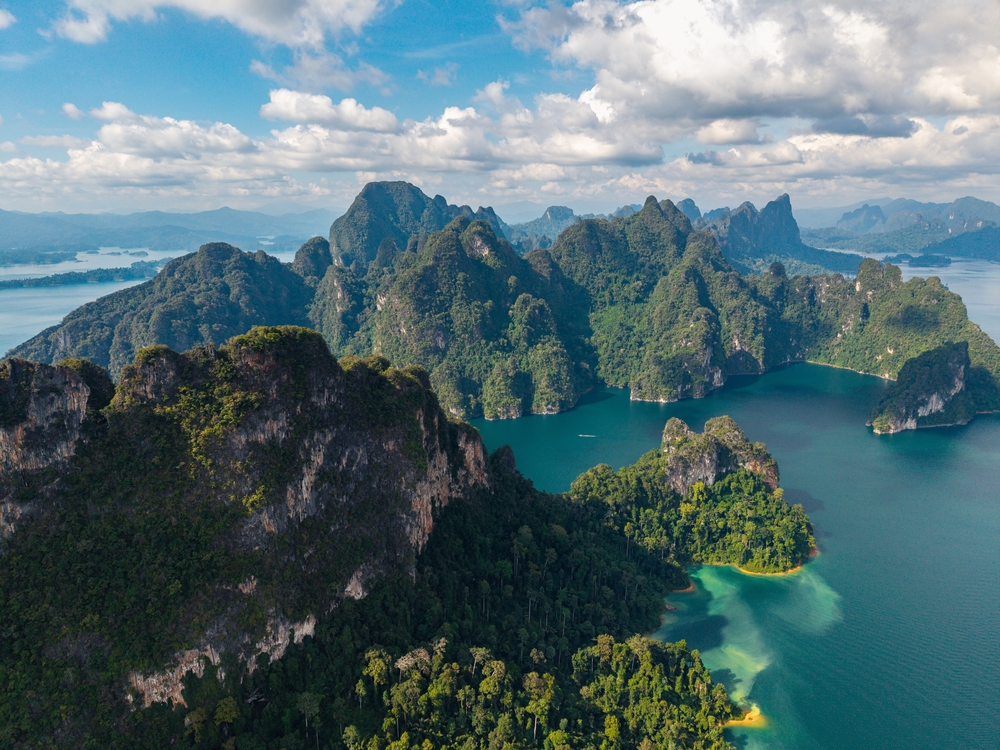 Top view of mountain ranges in the middle of turquoise waters in Khao Sok, Surat Thani, Thailand