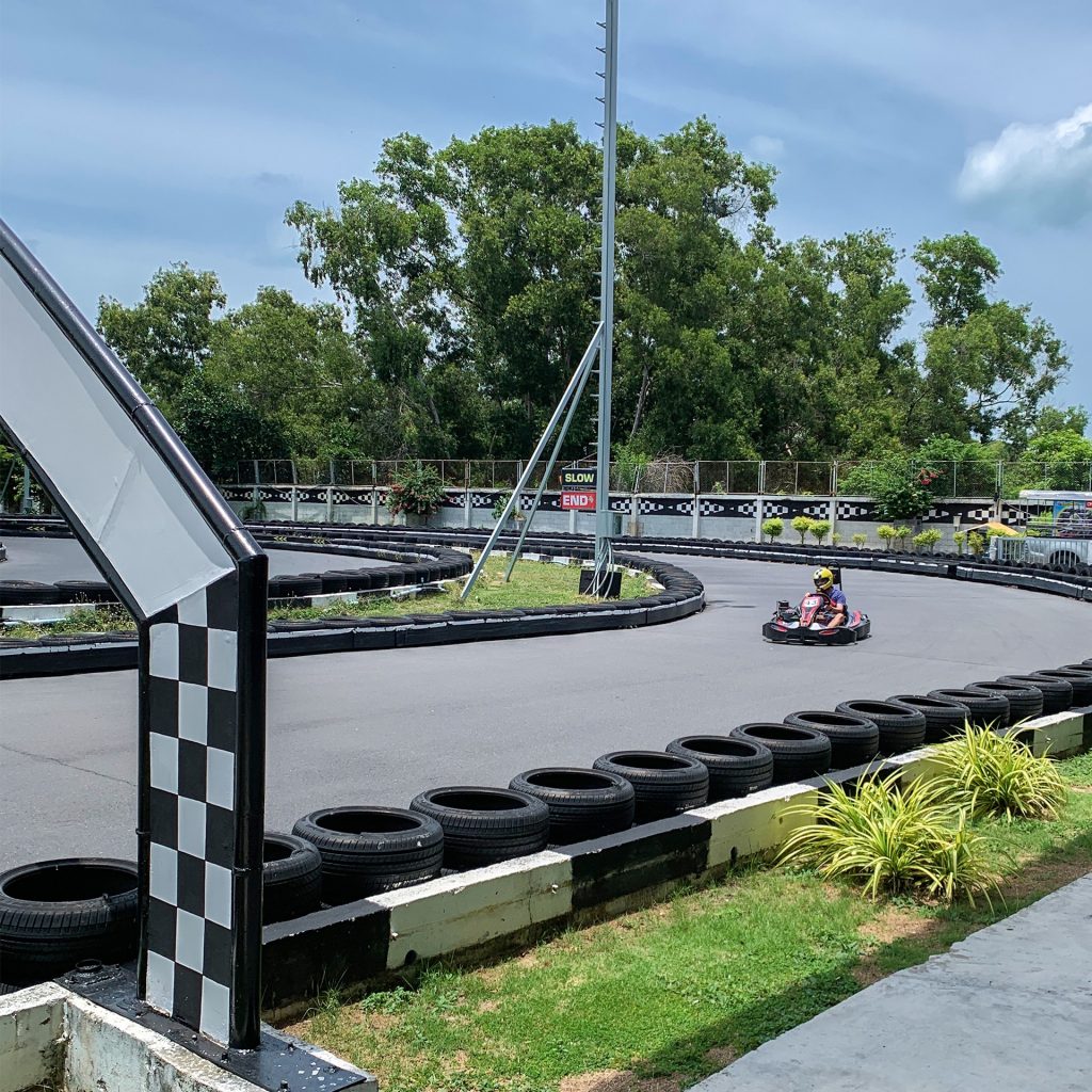 A person driving in a go-kart on a racing track in Koh Samui