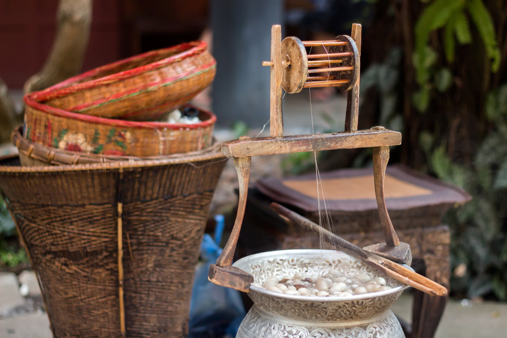 Process of Thai silk weaving with silkworm cocoons at the Jim Thompson House Museum