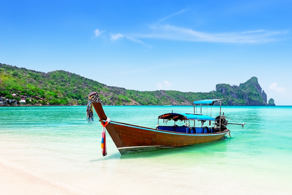 Long tail boat anchored on the beach on Koh Phi Phi, Krabi