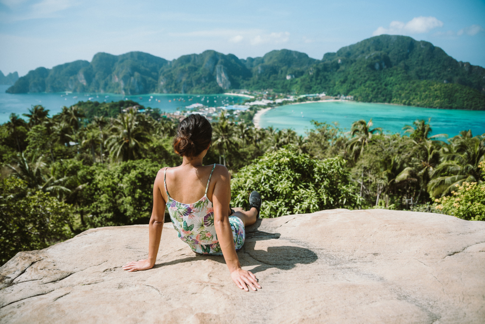 Woman sitting at the Phi Phi Viewpoint looking at the view of Koh Phi Phi