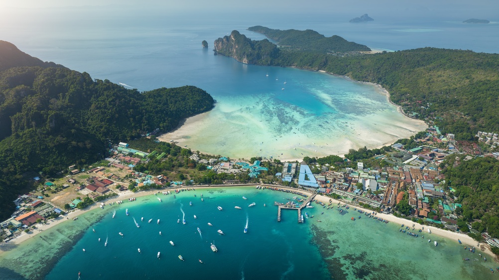 Aerial view of two bays including Loh Dalum Bay and a lush, green island of Koh Phi Phi
