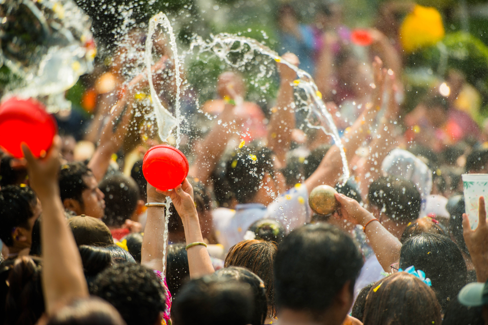 A crowd of people having a water fight during Songkran