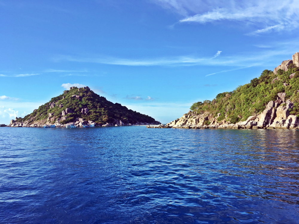 Diving point at Japanese Gardens near small islands in the middle of the blue sea in Koh Tao