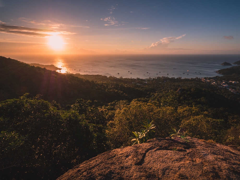 Sunset view at West Coast Viewpoint in Koh Tao above the green island and ocean horizon