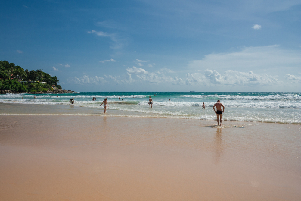 Tourists enjoying the waves of Kata Beach, Phuket