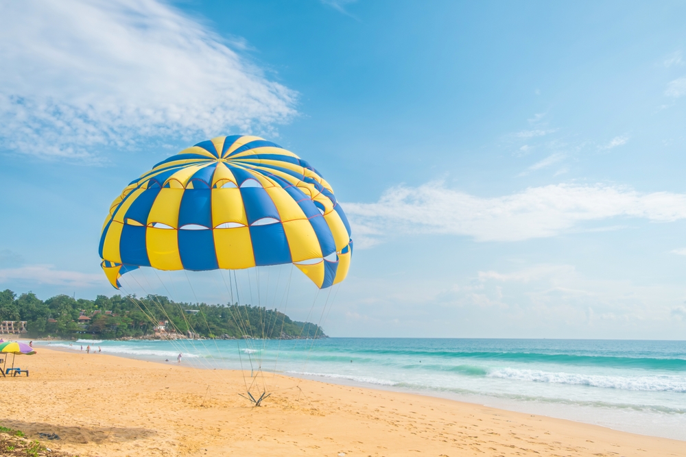 A colorful yellow and blue parasail on a beach in Phuket