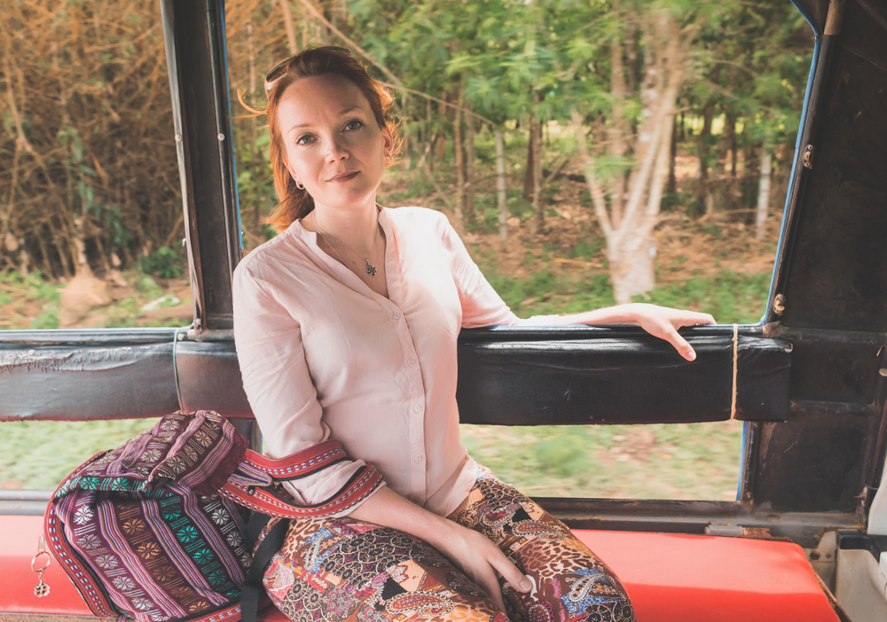 A young woman enjoying a ride on a Songthaew to get around Koh Chang.
