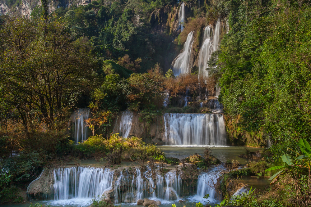 Thi Lo Su Waterfall in Tak, a massive waterfall in Thailand surrounded by lush tropical rainforest.