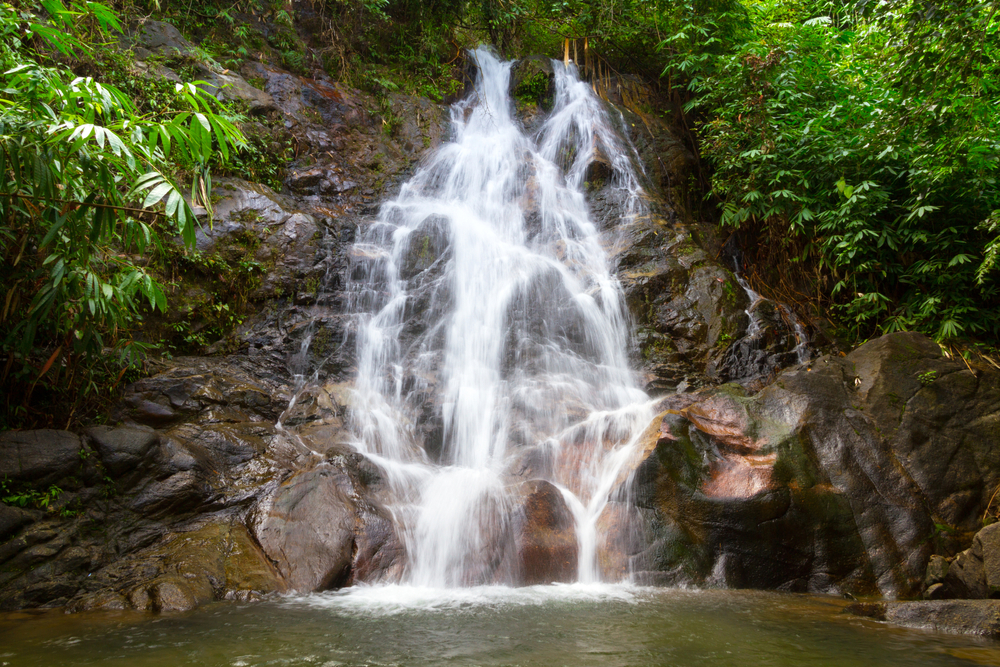 Sai Rung Waterfall in Sukhothai, a scenic waterfall in Thailand with water flowing gracefully over rocks in a national park.