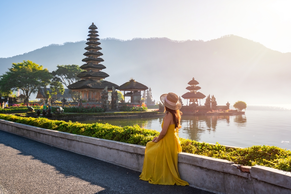 A woman admiring Ulun Danu Beratan Temple in Bali, one of the best islands in the world.