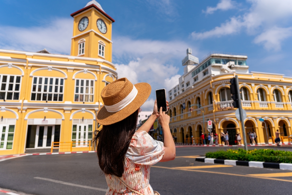 A tourist photographing Sino-Portuguese architecture in Phuket Old Town, one of the best islands in the world.