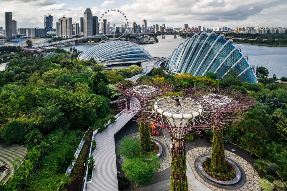 Supertree Grove and glass domes at Gardens by the Bay, Singapore, during the rainy season in Southeast Asia.