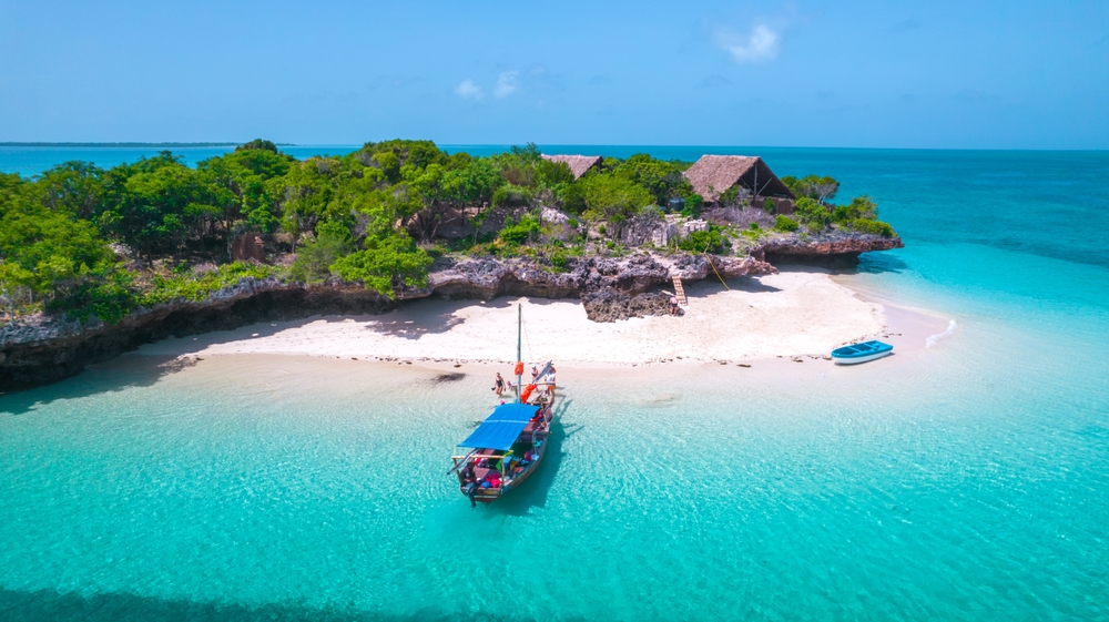 A traditional boat on crystal-clear water in Zanzibar, one of the best islands in the world.