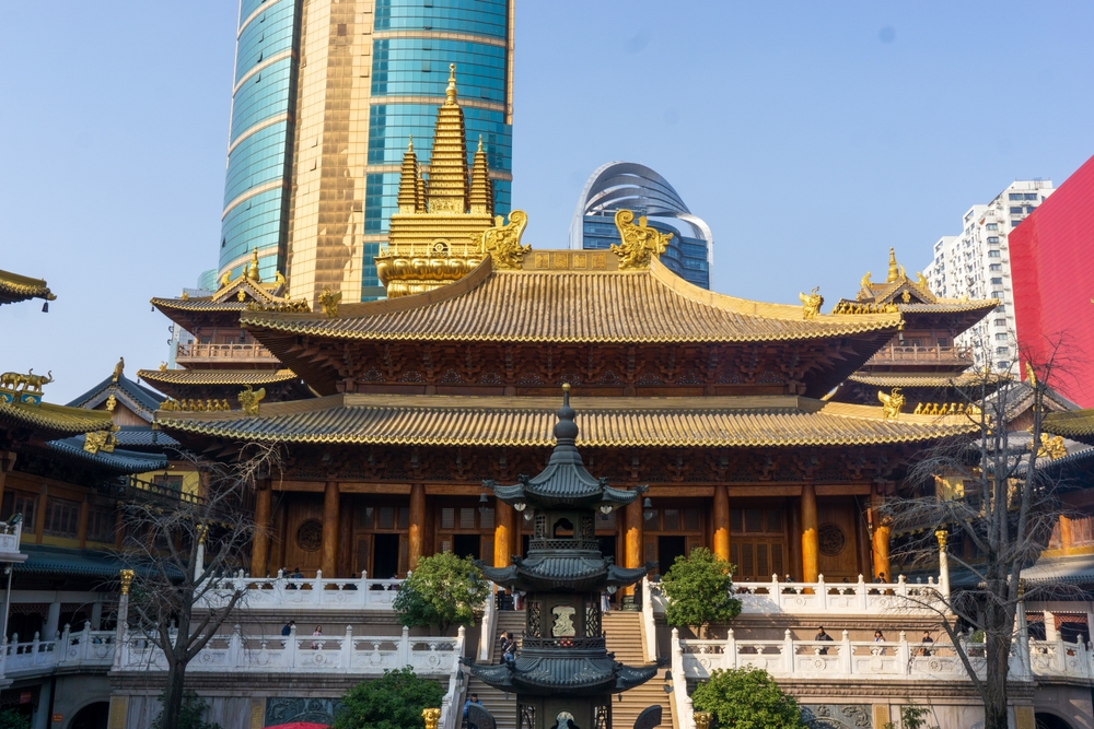 Traditional architecture at Jing'an Temple surrounded by modern skyscrapers in central Shanghai.