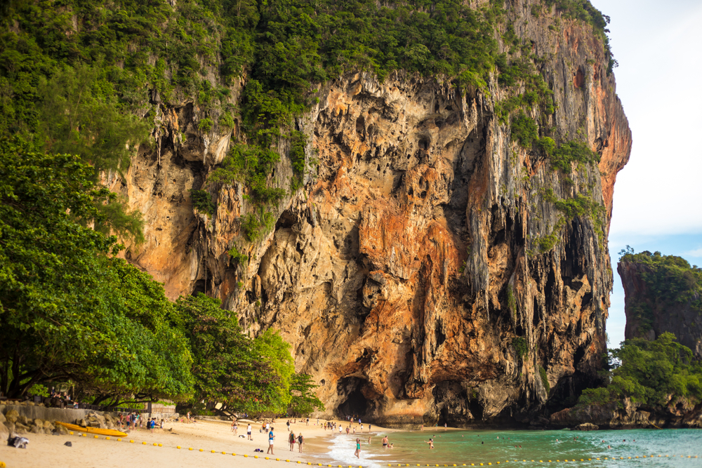 Tourists relaxing at Phra Nang Cave Beach, a popular day-trip destination from Ao Nang Beach in Krabi, Thailand.