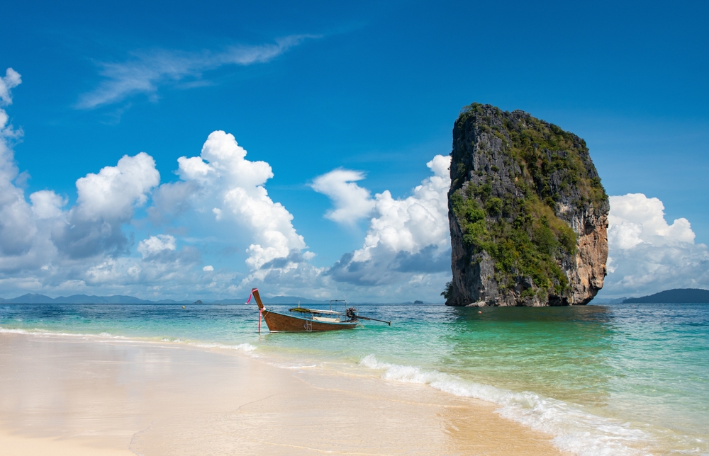 The iconic sail-shaped limestone rock rising from the clear waters of Koh Poda, near Ao Nang Beach in Krabi.