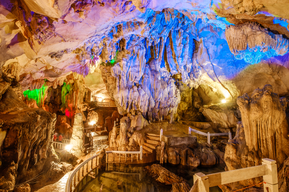 Illuminated stalactites and rock formations inside Tham Chang Cave, a famous nature attraction in Vang Vieng.