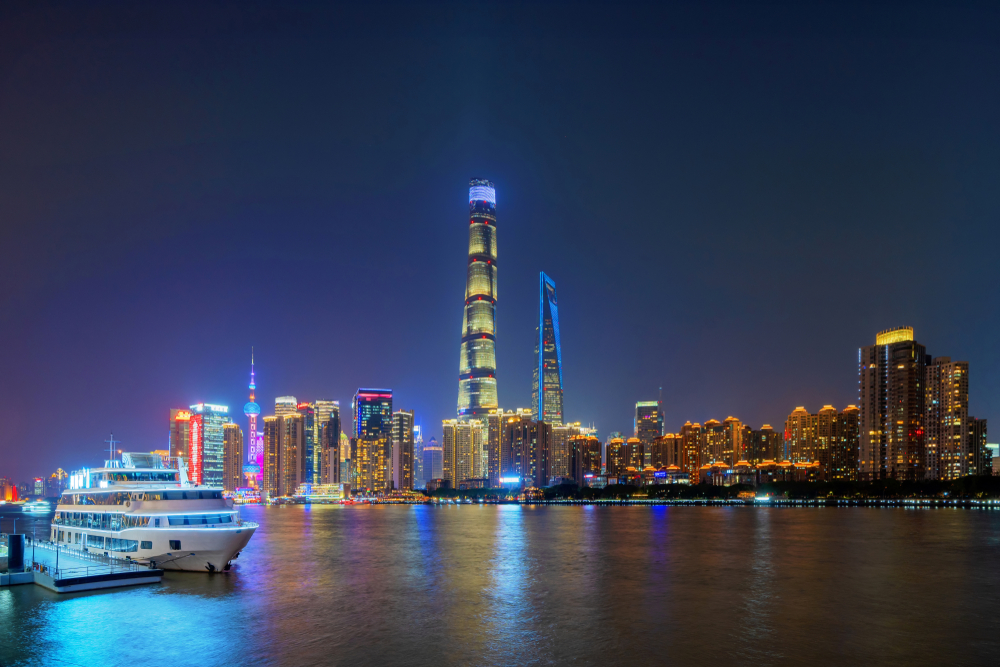 The illuminated Lujiazui skyline viewed from a spectacular Huangpu River cruise in Shanghai at night.